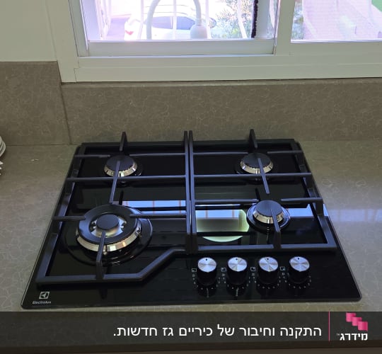 כיריים גז במטבח עם חלון פתוח